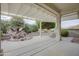 Covered patio with water feature and seating area at 17733 N Escalante Ln, Surprise, AZ 85374