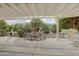 Covered patio with water feature and seating area at 17733 N Escalante Ln, Surprise, AZ 85374