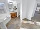 Bathroom features a soaking tub, toilet, and vanity with wood cabinets at 18164 W Smokey Dr, Surprise, AZ 85388
