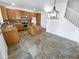 Kitchen with island, granite counters, and wood cabinets at 18164 W Smokey Dr, Surprise, AZ 85388