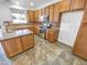 Kitchen with wood cabinets, granite counters and island at 18164 W Smokey Dr, Surprise, AZ 85388