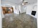 Open living room with tile floors and a fireplace at 18164 W Smokey Dr, Surprise, AZ 85388
