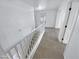 Upstairs hallway with carpet and white railing at 18164 W Smokey Dr, Surprise, AZ 85388