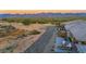 Elevated view of backyard patio, landscaping, and mountain backdrop at 18324 E Spring Valley Ct, Rio Verde, AZ 85263