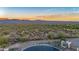 Aerial view of homes with mountain views at sunset at 18324 E Spring Valley Ct, Rio Verde, AZ 85263