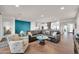 Spacious living room with a teal accent wall, comfortable seating, and kitchen access at 18324 E Spring Valley Ct, Rio Verde, AZ 85263