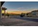 View of neighborhood with mountain background at sunset at 18324 E Spring Valley Ct, Rio Verde, AZ 85263