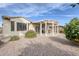 Private backyard with covered patio and mature plants at 19043 N Aztec Point Dr, Surprise, AZ 85387