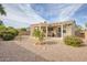 Landscaped backyard with a pergola covered patio at 19043 N Aztec Point Dr, Surprise, AZ 85387