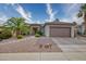 Single-story home with a two-car garage and desert landscaping at 19043 N Aztec Point Dr, Surprise, AZ 85387