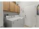 Laundry room with washer, dryer, and cabinets at 19043 N Aztec Point Dr, Surprise, AZ 85387
