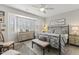 Spacious bedroom with a large bed and bay window at 19043 N Aztec Point Dr, Surprise, AZ 85387