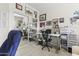 Home office with a desk, chair, and mirrored closet at 19043 N Aztec Point Dr, Surprise, AZ 85387