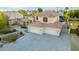 Two-story house with tile roof, three-car garage, and a landscaped yard at 2042 E Victor Rd Rd, Gilbert, AZ 85296