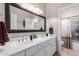 Double vanity bathroom with large mirror and shower at 2042 E Victor Rd Rd, Gilbert, AZ 85296