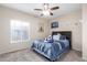Bright bedroom with ceiling fan and a comfy bed at 2042 E Victor Rd Rd, Gilbert, AZ 85296