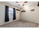 Bright bedroom with large window and ceiling fan at 2042 E Victor Rd Rd, Gilbert, AZ 85296