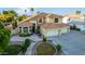Two-story house with tile roof, three-car garage, and landscaped yard at 2042 E Victor Rd Rd, Gilbert, AZ 85296