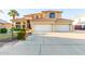 Two-story house with tile roof, three-car garage, and nicely landscaped front yard at 2042 E Victor Rd Rd, Gilbert, AZ 85296
