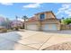 Two-story house with tile roof, three-car garage, and a large driveway at 2042 E Victor Rd Rd, Gilbert, AZ 85296