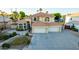 Two-story house with tile roof, three-car garage, and landscaped yard at 2042 E Victor Rd Rd, Gilbert, AZ 85296
