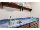 Laundry room with utility sink and shelving at 2042 E Victor Rd Rd, Gilbert, AZ 85296