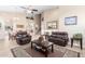 Open living room with leather furniture and large windows at 2042 E Victor Rd Rd, Gilbert, AZ 85296