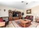 Gathering room with large TV, leather furniture, and wood flooring at 2042 E Victor Rd Rd, Gilbert, AZ 85296