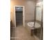 Bathroom showcasing bathtub with glass enclosure and views into the walk-in closet at 2335 W Muirfield Dr, Anthem, AZ 85086