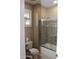 Bathroom features a shower with glass doors, a window, and toilet at 2335 W Muirfield Dr, Anthem, AZ 85086