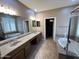 Spacious primary bathroom with dual sinks, vanity, tub, and walk-in closet access at 2335 W Muirfield Dr, Anthem, AZ 85086