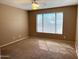 Neutral bedroom with a ceiling fan and a large window for plenty of natural light at 2335 W Muirfield Dr, Anthem, AZ 85086