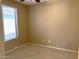 Neutral bedroom with a large window for plenty of natural light and neutral carpet at 2335 W Muirfield Dr, Anthem, AZ 85086