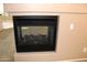 Close up of the modern fireplace with glass front and neutral colored mantle in the living room at 2335 W Muirfield Dr, Anthem, AZ 85086