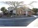 Inviting single-story home featuring desert landscaping and a two-car garage under a clear, sunny sky at 2335 W Muirfield Dr, Anthem, AZ 85086