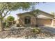 Inviting single-story home featuring a desert-landscaped yard, a two-car garage, and a charming front entrance at 2335 W Muirfield Dr, Anthem, AZ 85086