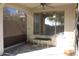 Covered patio with decorative rug, furniture and shade screens for added comfort at 2335 W Muirfield Dr, Anthem, AZ 85086
