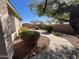 Landscaped side yard with walkway and mature trees at 2335 W Muirfield Dr, Anthem, AZ 85086