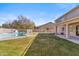 Spacious backyard with a refreshing pool, grassy area, and covered patio at 2380 W Megan St, Chandler, AZ 85224