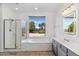 Bathroom with a large soaking tub, shower, and window at 2380 W Megan St, Chandler, AZ 85224