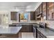 Kitchen with dark wood cabinets and granite countertops at 2380 W Megan St, Chandler, AZ 85224