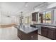Kitchen with dark cabinets, island, and stainless steel appliances at 2380 W Megan St, Chandler, AZ 85224
