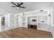 Living area with hardwood floors, ceiling fan, and built-in entertainment center at 2380 W Megan St, Chandler, AZ 85224