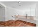 Bright loft area with hardwood floors and wood railing at 2380 W Megan St, Chandler, AZ 85224