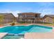 Inviting swimming pool in a large backyard with a two-story home at 2380 W Megan St, Chandler, AZ 85224