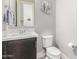 Half bath with a floating vanity and modern fixtures at 25311 N 19Th Ln, Phoenix, AZ 85085