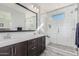 The primary bathroom features double sinks, a large mirror, and a glass-enclosed shower at 25311 N 19Th Ln, Phoenix, AZ 85085