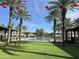 Resort-style community pool surrounded by palm trees, green space, and lounge seating at 25311 N 19Th Ln, Phoenix, AZ 85085