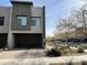 Contemporary townhome featuring a gray facade, large windows, and a private garage at 25311 N 19Th Ln, Phoenix, AZ 85085