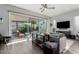The living room features a glass sliding door to the covered patio and a comfortable seating arrangement at 25311 N 19Th Ln, Phoenix, AZ 85085